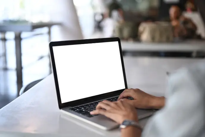 Man with a laptop finding out how TRaViS can help protect your business with it's exposed API feature.