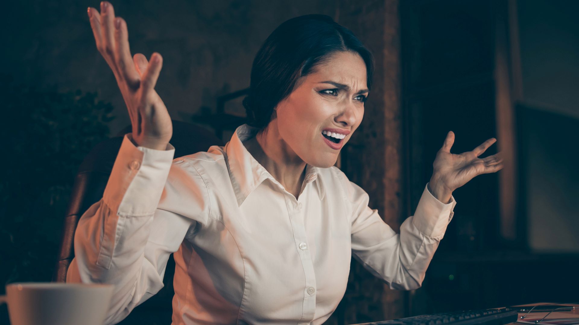 Frustrated businesswoman at her desk, illustrating the potential negative outcomes of not enhancing investor confidence for tech startups.