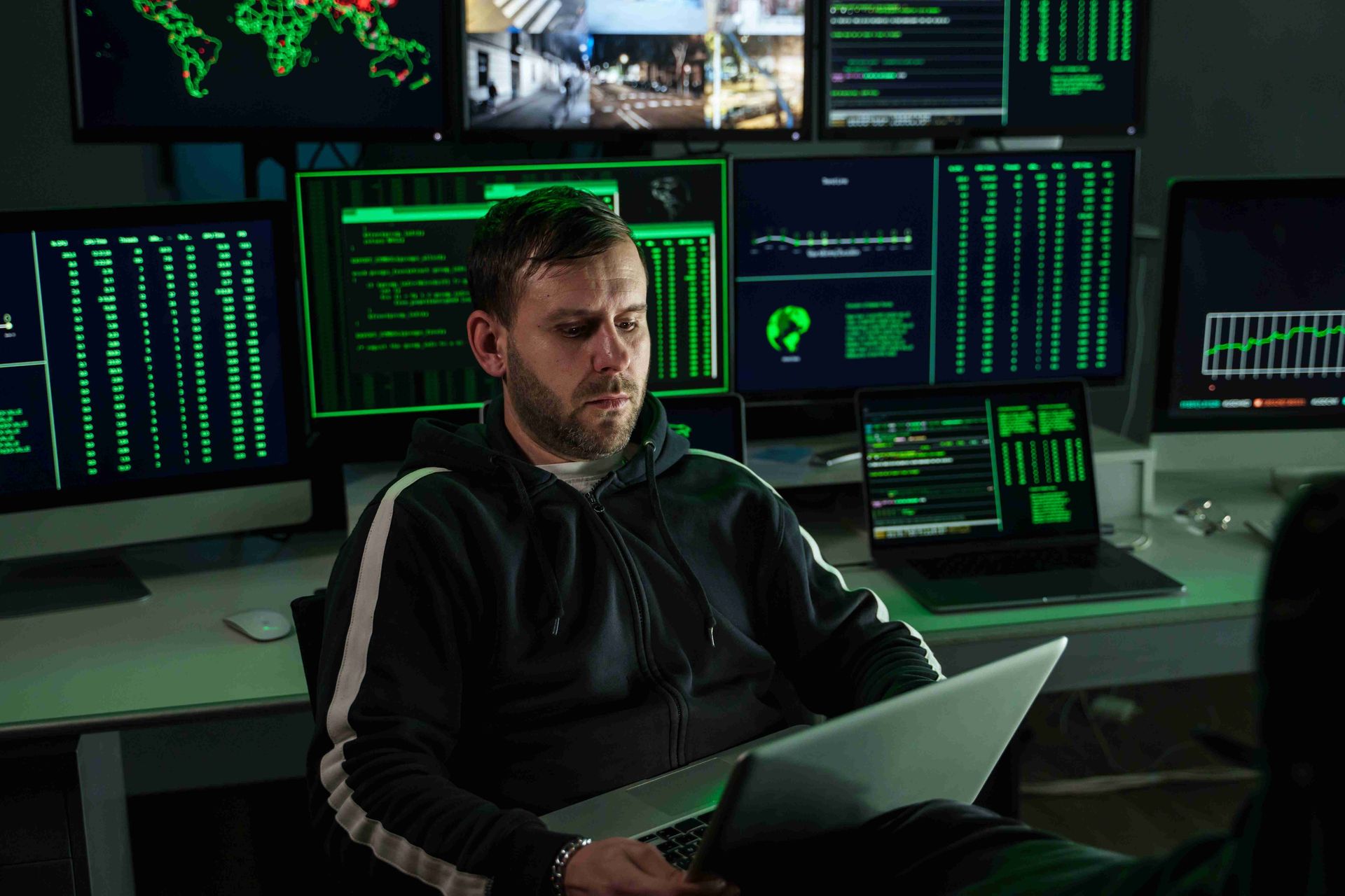 Cybersecurity Analyst Managing Attack Surface with Multiple Monitors