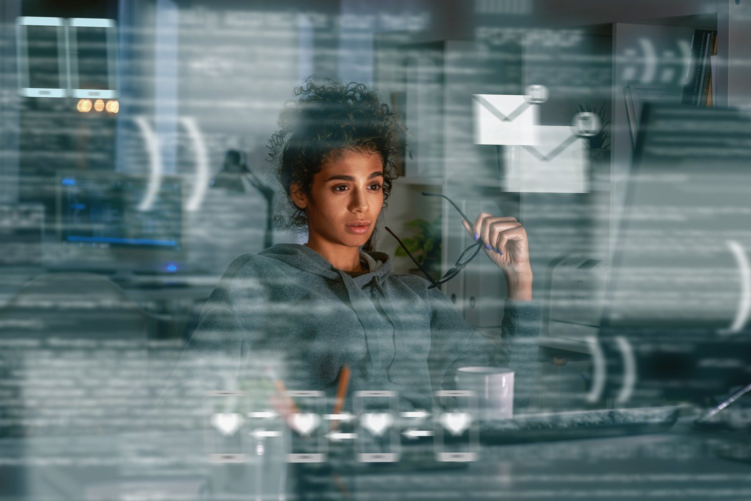 Image of a woman in cybersecurity considering the role of threat intelligence in the dark web breach prevention sector.