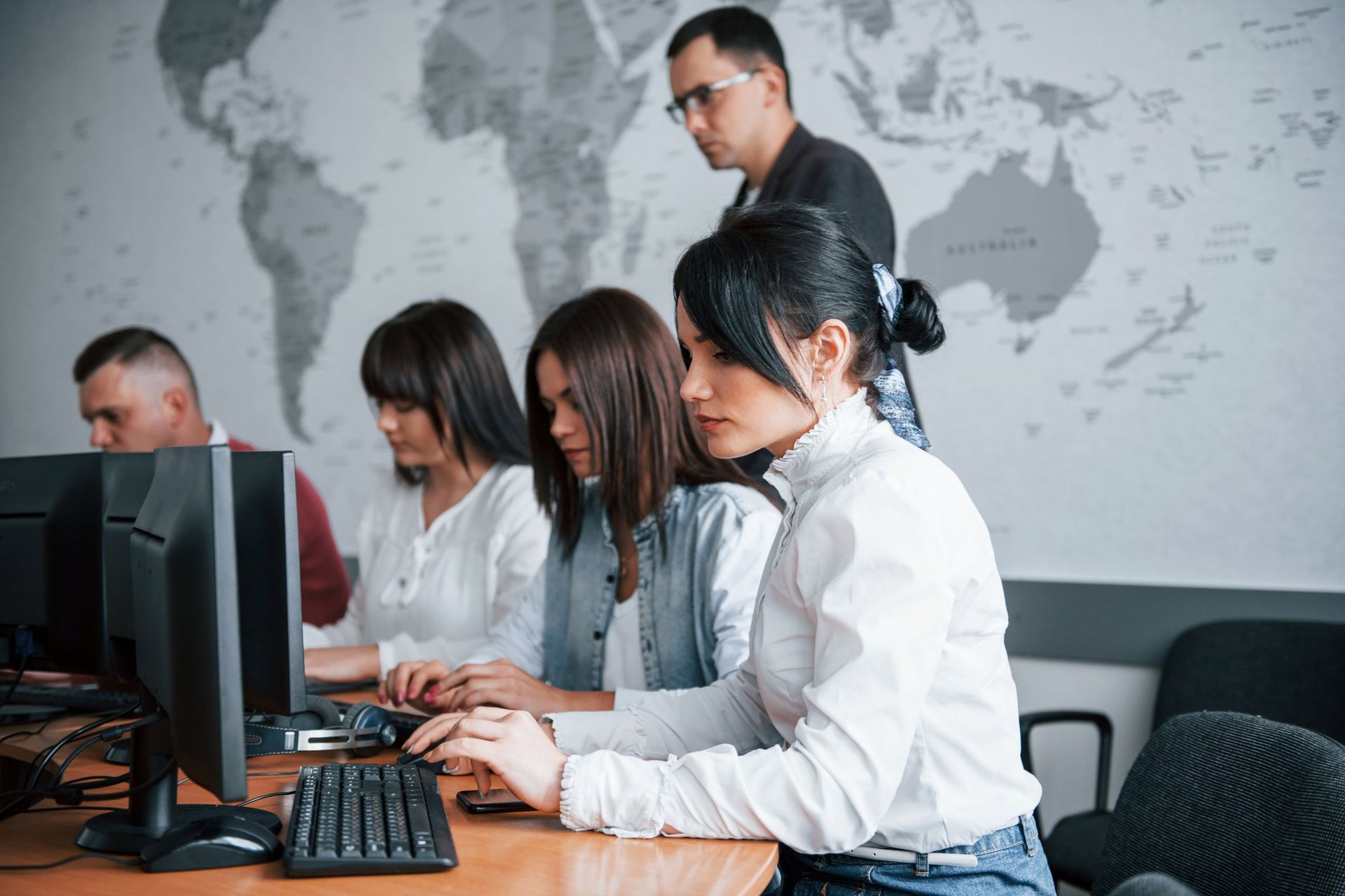 Cybersecurity team analyzing external attack surface on computers, symbolizing TRaViS EASM empowering teams to detect vulnerabilities and improve resilience.