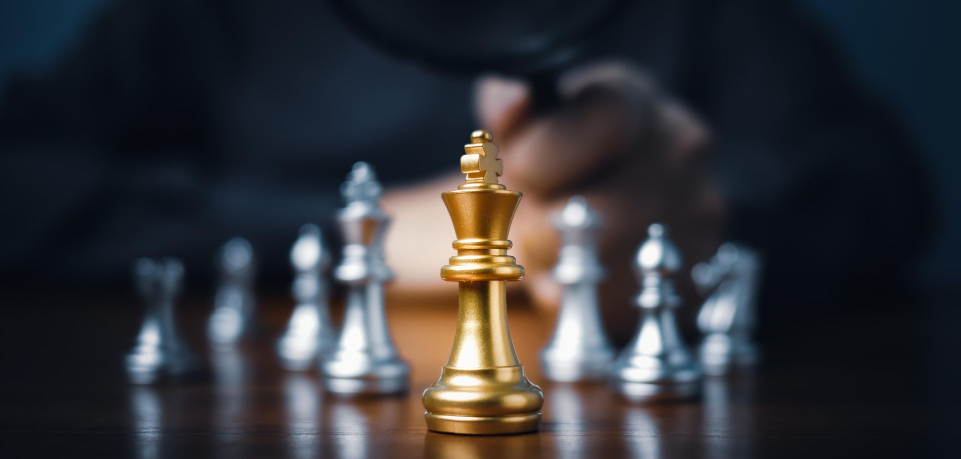 Image of a chess player playing chess symbolizing real world business implications. Image of a chess player playing chess symbolizing real world business implications.
