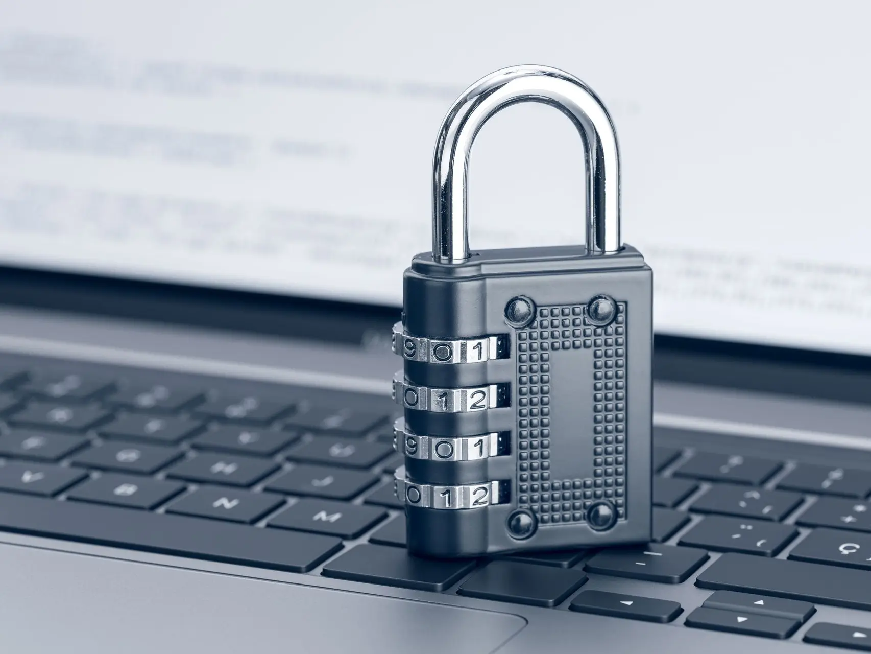 Image of a lock on a keyboard representing TRaViS EASM's ability to prevent breaches for financial protection.