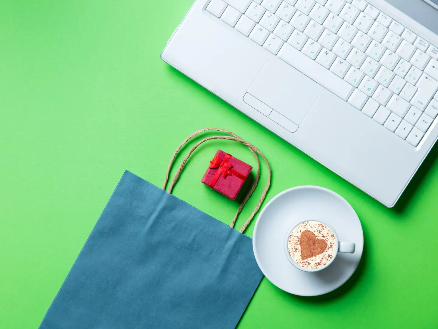 Image showing a laptop on a desk next to a cup of espresso.