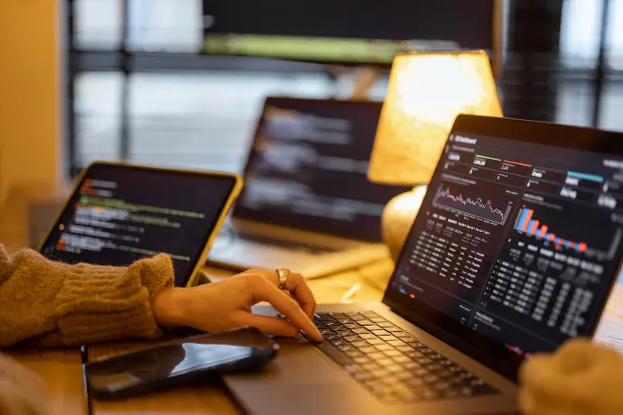 Image of a human with a laptop looking at cybersecurity services.