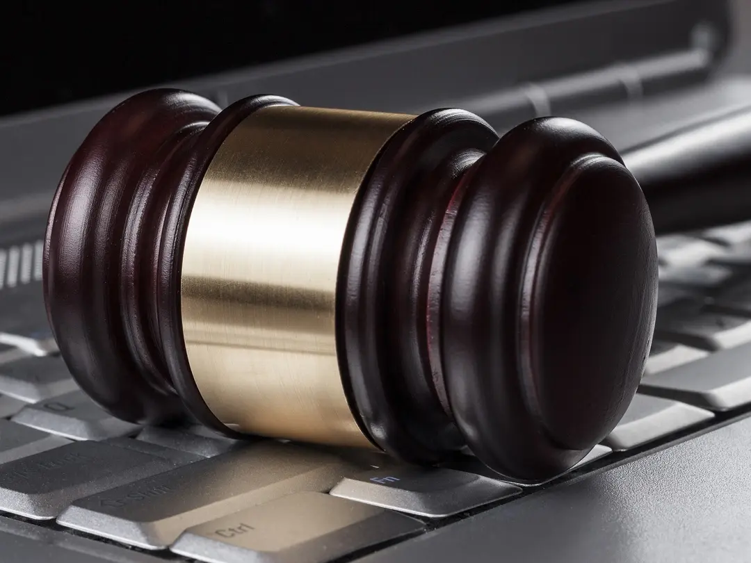 A gavel on a laptop.