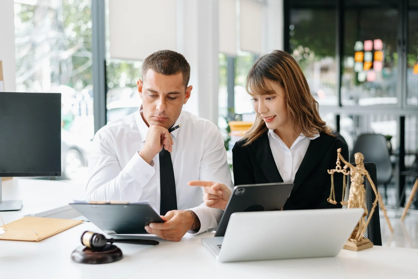 Man and woman looking at secure sensitive legal data.