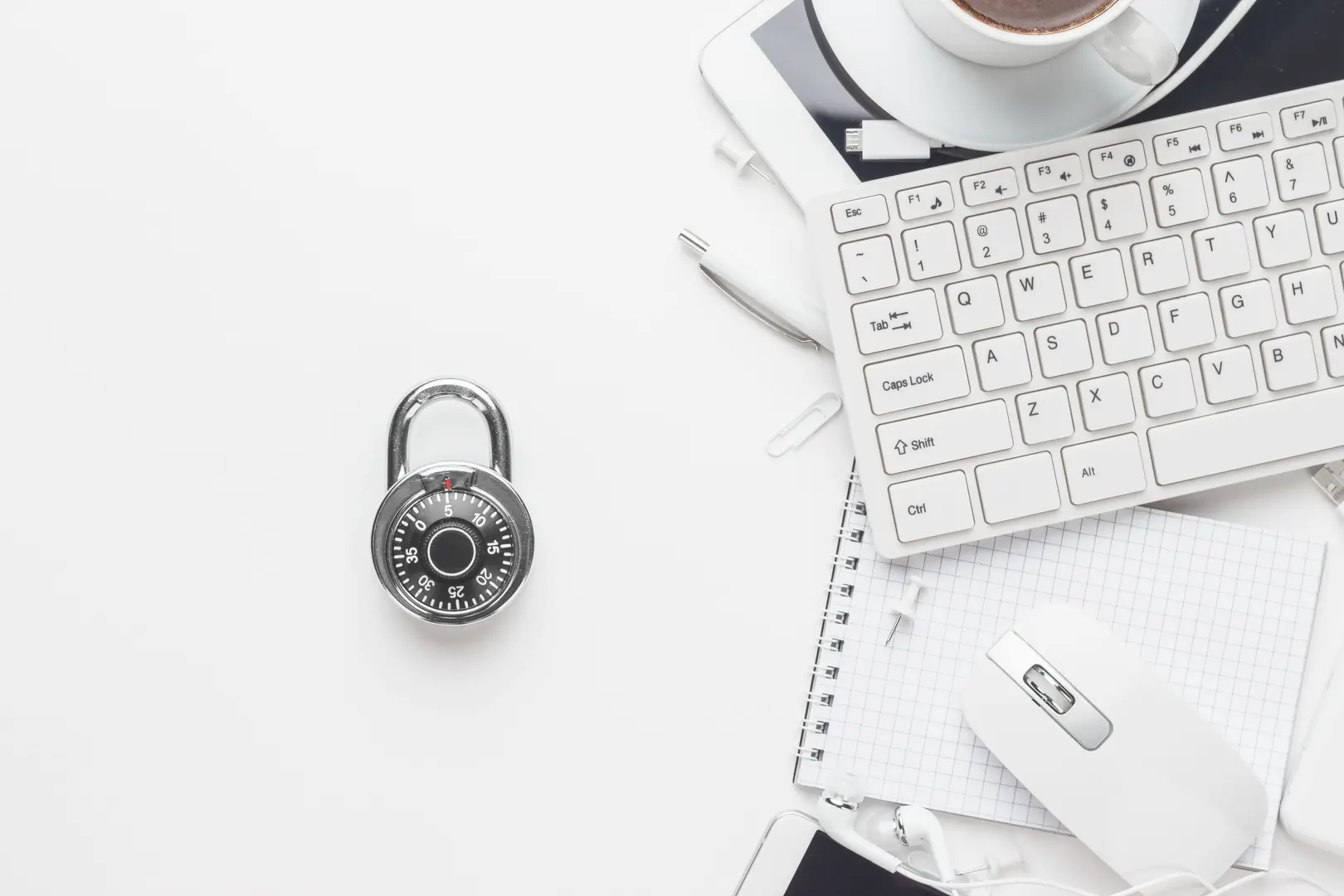 Image of a desk in a financial institution with a lock, keyboard and other desk items.